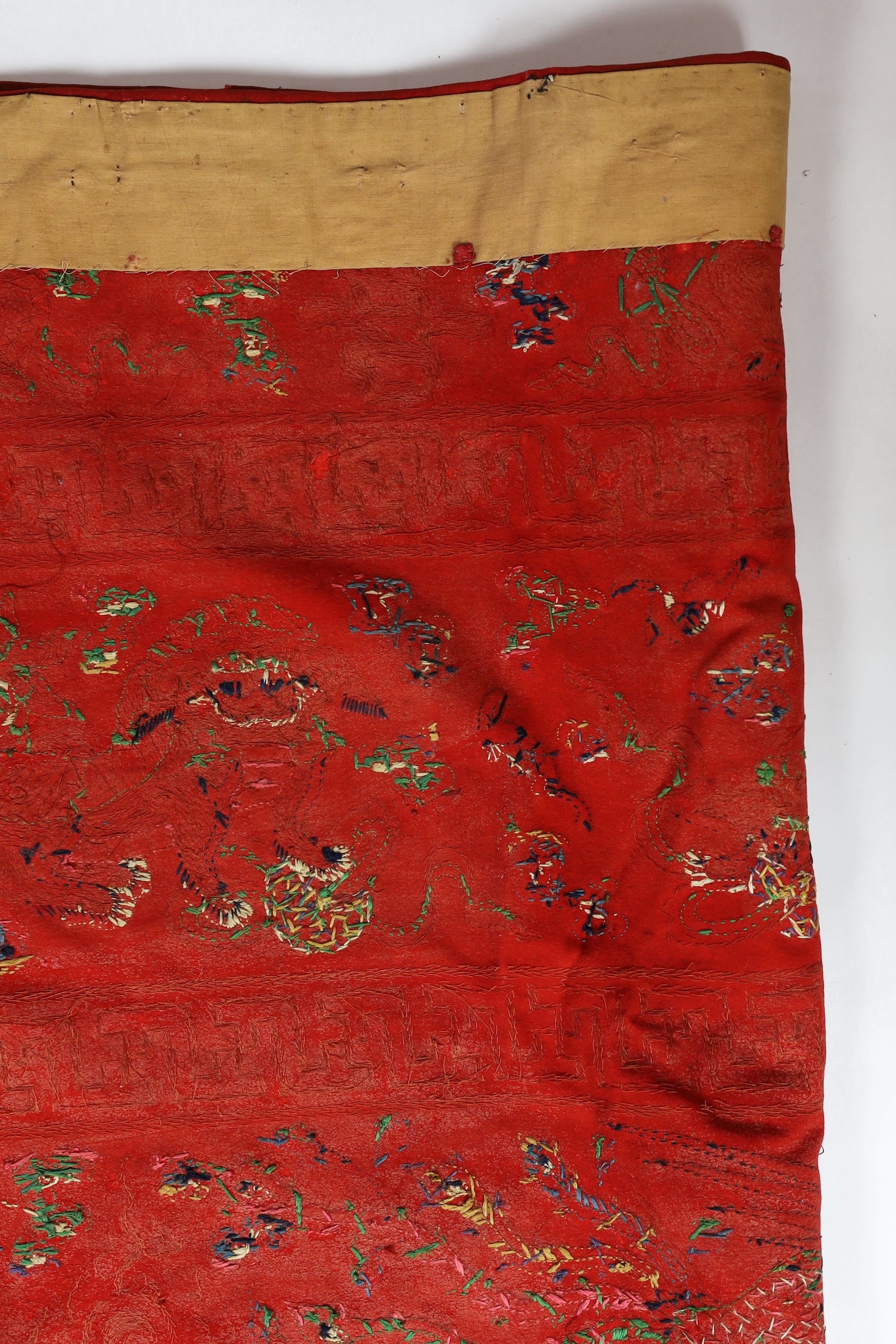 A Chinese embroidered silk ‘dragon, phoenix and lion’ panel or table frontal, late Qing dynasty, 117cm x 337cm
